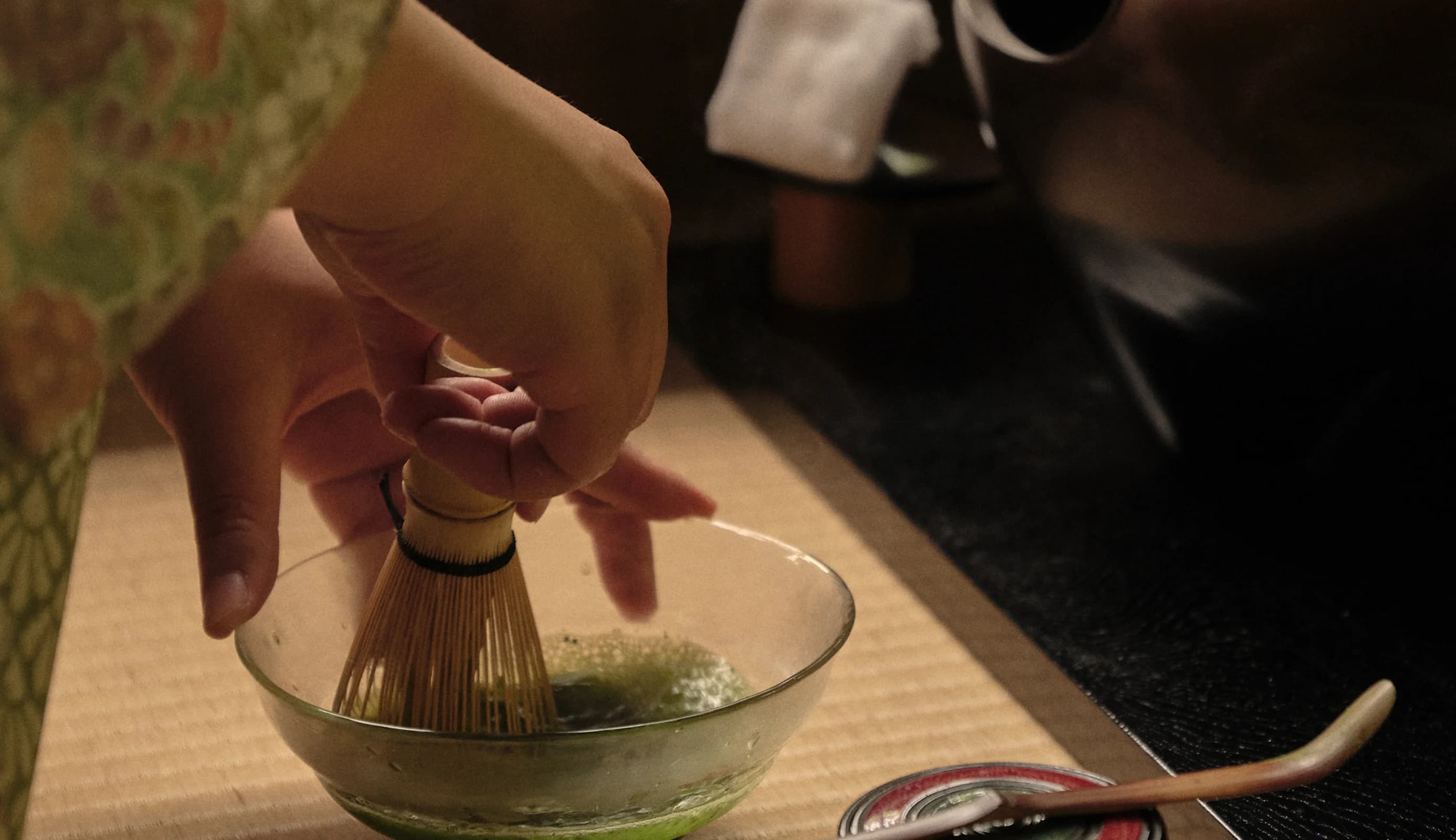 Woman in traditional Japanese clothing preparing tea